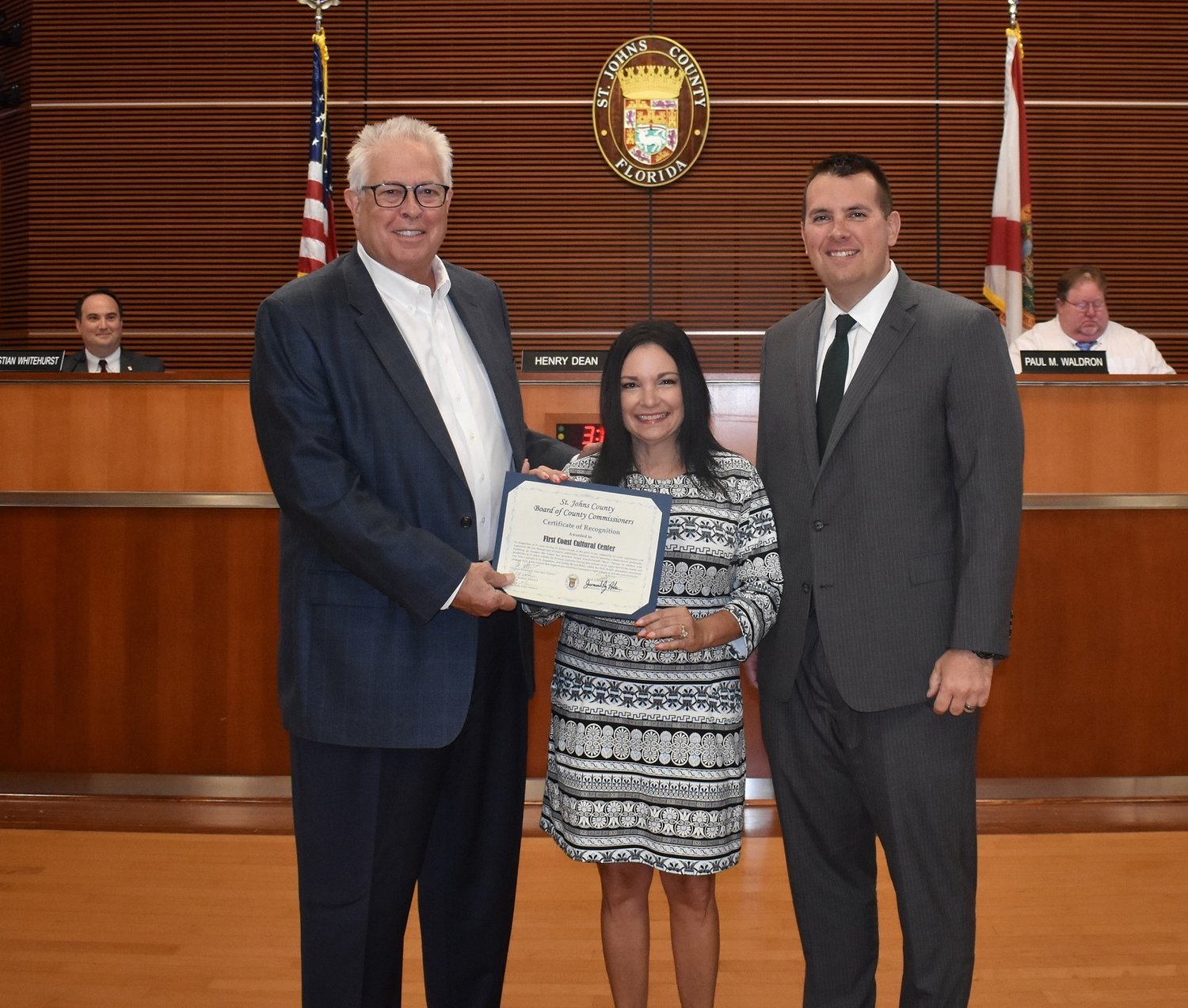 St. Johns County Commissioner Jeremiah Blocker, right, presents First Coast Cultural Center board chair Joe Bryant and Donna Guzzo, president and executive director, a certificate of recognition.
